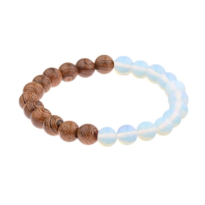 Detail of beaded bracelet featuring dark brown wood grain beads and white opal-like stones