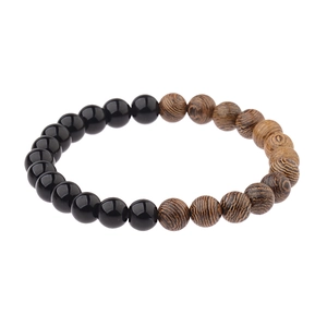 Detailed close-up showing black obsidian and dark brown wood grain beads on the bracelet