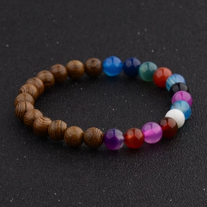 Detail of beaded bracelet showing mixed wood grain beads and colorful crystal gems