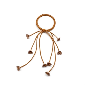 Detailed close-up of brown braided hair tie featuring elegant hanging flower pendants