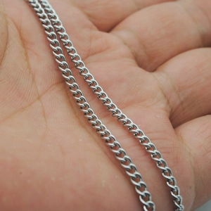 Polished silver curb chain necklace in 304 stainless steel shown on hand for scale