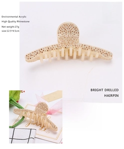 Detail view of large champagne shark hair claw clip with rhinestones and size measurements