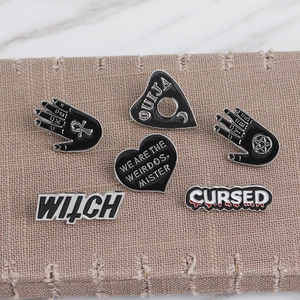 Gothic punk enamel pins set featuring Witch Ouija and Cursed heart motifs on linen background