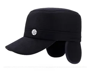 Detail view of black winter flat top army cap with ear protection and silver star badge