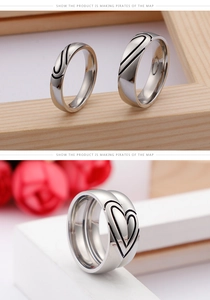 Close-up of heart-shaped puzzle couple rings with rose flower detail and wood texture