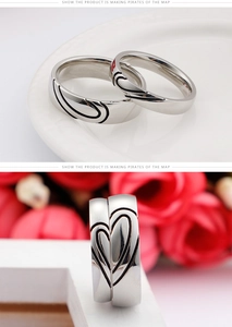 Detail of silver heart-matching couple rings with romantic split heart engraving