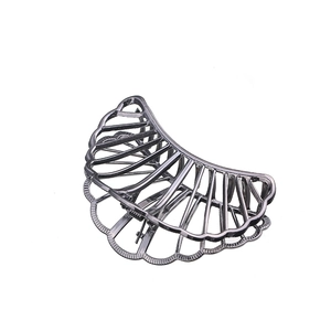 Minimalist silver hollow fan-shaped metal hair claw clip with a glossy finish on white