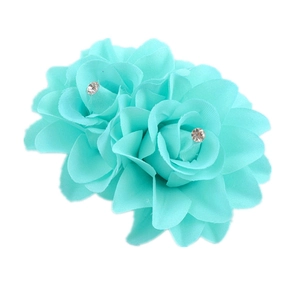 Detail of dual mint green fabric roses with sparkling rhinestone centers hair clip