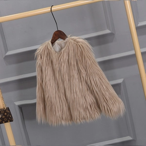 Close-up of the fluffy faux fur texture on a thick camel-colored girl's winter coat