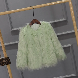 Detail of mint green faux fur coat texture and soft inner lining on a hanger