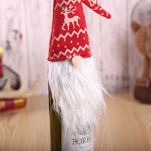 Red knitted Christmas gnome wine bottle cover with white reindeer pattern and beard