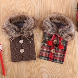 Christmas wine bottle covers with faux fur collars and festive patterns on wood background
