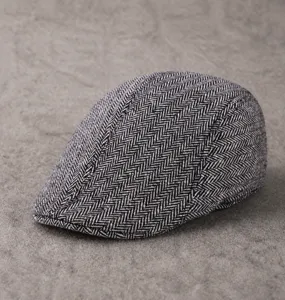 Detailed close-up of thickened herringbone newsboy cap for elderly men with wool finish