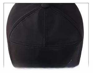 Close-up of durable black baseball cap top showing reinforced stitching and fabric texture
