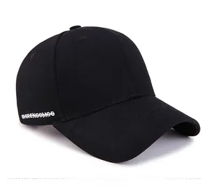 Detail view of black cotton baseball cap with white side embroidery text GEGEENBOMOO