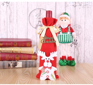 Detail of red Christmas wine bottle cover with golden bow and 3D reindeer embroidery