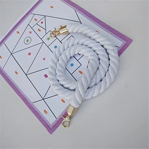 Detail of white cotton twisted rope strap with golden metal swivel snap hooks