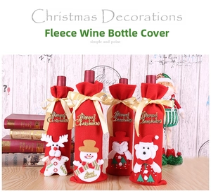 Detail of Christmas wine bottle cover made of soft red fleece fabric with festive character