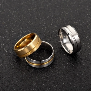 Detail of brushed stainless steel rings with polished grooves in gold and silver