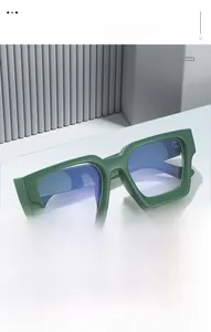 Detailed close-up of dark green thick-frame square glasses with blue light blocking lenses