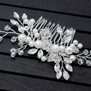 Macro detail of bridal hair comb with pearls and marquise-cut crystals on silver wire