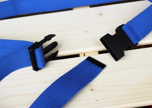 Close-up of blue polyester webbing texture with black durable plastic buckle detail
