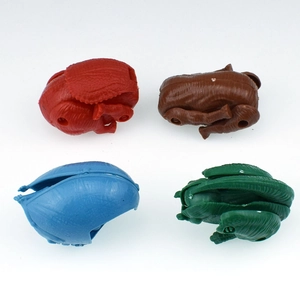 Top-down view of 4-pack dinosaur deformation egg toys in red, brown, blue, and green colors