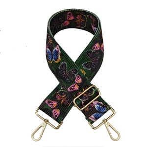 Close-up of ethnic style wide colorful butterfly print bag strap with gold metal buckles