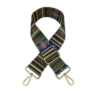 Detail of colorful geometric ethnic style bag strap with adjustable gold buckles