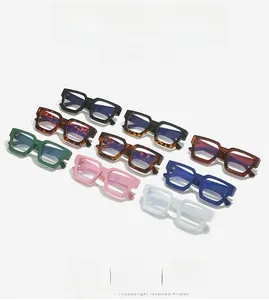 Detail view of colorful thick-frame rectangle eyeglasses in black, blue, and tortoise patterns