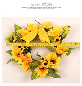 Detail view of 13.5 inch artificial sunflower wreath with a yellow polka dot bow accent