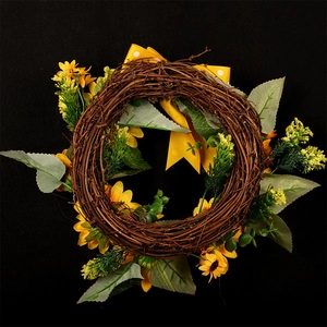 Artificial sunflower wreath with yellow bow and green leaves on vine base for wall decor