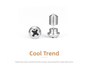 Macro detail of industrial style silver screw earrings with cross-head and thread texture