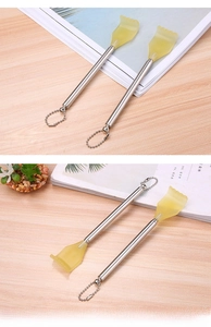 Detail of extendable back scratcher with smooth resin claw and hanging metal chain