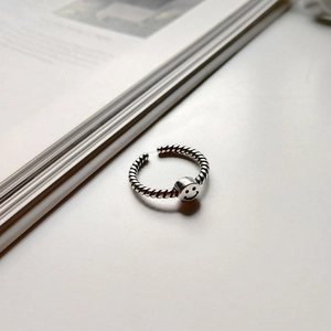 Detail of S925 sterling silver smile face bead ring with vintage twisted rope texture