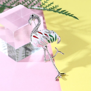 Sparkling flamingo brooch with colorful enamel and rhinestones on vibrant background