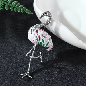 Elegant flamingo brooch with colorful enamel and sparkling rhinestones on black background