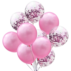 Close-up of metallic pink latex balloons and clear balloons with pink paper confetti