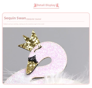 Macro detail of sequin swan hair clip with pink glitter crown and soft white feathers