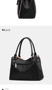 Détail du sac à main en cuir noir souple montrant la poche zippée et les pièces dorées