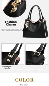 Détail de la poignée renforcée du sac à main noir avec pendentif chat doré et métal