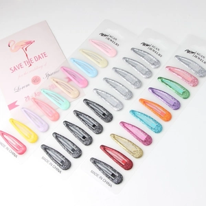 Detail view of colorful metallic snap hair clips in solid matte and glitter finishes