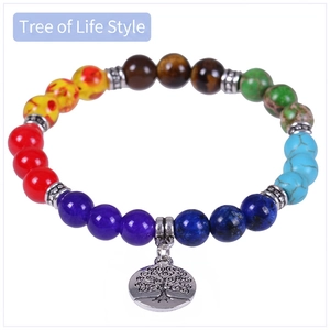 Detail of multi-color chakra beads with a silver Tree of Life pendant and metal spacers