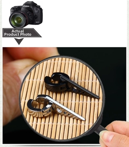Detailed macro view of punk style silver and black cone earrings with clip-on design
