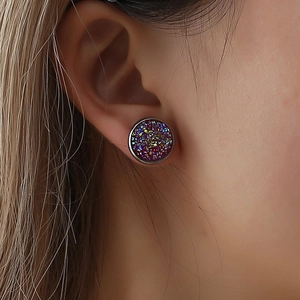 Iridescent purple druzy crystal stud earrings in silver settings on model ear
