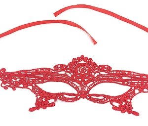 Detailed view of red lace eye mask with satin ribbons laid flat on white background