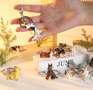 Detail of 3D zinc alloy dog keychain featuring a Corgi charm with metal bone accessory