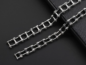 Macro detail of industrial bike chain style bracelets in silver and black metal