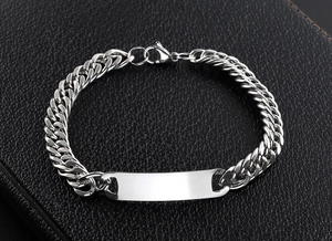 Macro detail of silver Cuban link bracelet with a blank rectangular metal plate