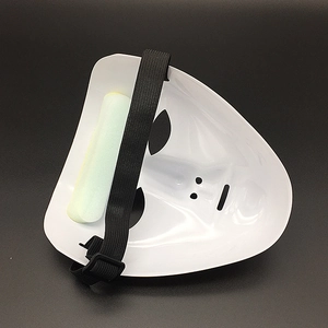 Detail of white Halloween mask back with black elastic strap and green forehead sponge